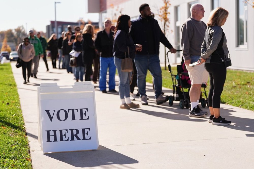 Voters wait in line to cast there ballot at a polling place at Rowan College in Mount Laurel, N.J., Monday, Oct. 27, 2025. (AP Photo/Matt Rourke)