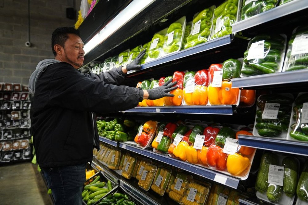 A grocery store employee stocks produce, which is covered by the USDA Supplemental Nutrition Assistance Program (SNAP), at a grocery store in Baltimore, Thursday, Oct. 30, 2025. (AP Photo/Stephanie Scarbrough)