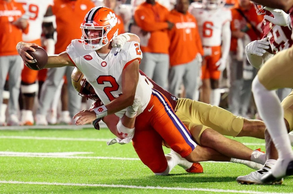 Clemson quarterback Cade Klubnik (2) reaches out for a first down during the first half of an NCAA college football game against Clemson, Saturday, Oct. 11, 2025 in Boston. (AP Photo/Mark Stockwell)
