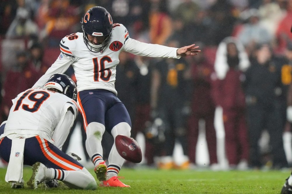 Chicago Bears kicker Jake Moody (16) kicks the game-winning field goal off the hold by punter Tory Taylor as time expires in an NFL football game against the Washington Commanders, Monday, Oct. 13, 2025, in Landover, Md. (AP Photo/Stephanie Scarbrough)