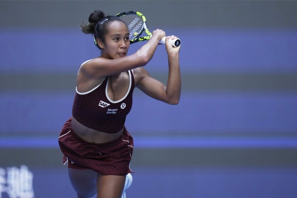 Leylah Fernandez of Canada plays a backhand return to Coco Gauff of the United States during a women's singles match of the China Open tennis tournament, at the National Tennis Center, in Beijing, China, Sunday, Sept. 28, 2025. (AP Photo/Mahesh Kumar A.)