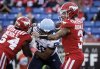 Toronto Argonauts' Da'Marcus Johnson, centre, closes in on Calgary Stampeders quarterback Vernon Adams Jr. during first half CFL football action in Calgary, Saturday, Oct. 18, 2025. THE CANADIAN PRESS/Jeff McIntosh