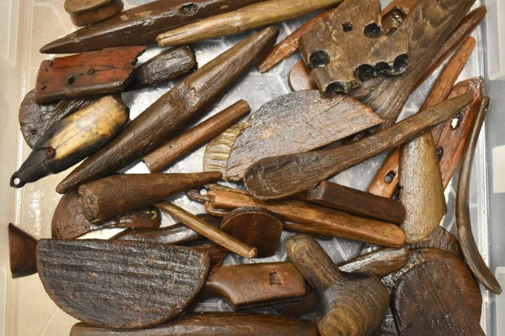 This photo provided by Richard Arden Knecht shows various tools, utensils and other artifacts that were recovered after the Typhoon Halong scattered them from a significant Yup'ik archaeological site, known as the Nunalleq site, in Quinhagak, Alaska, Oct. 2025. (Richard Arden Knecht via AP)