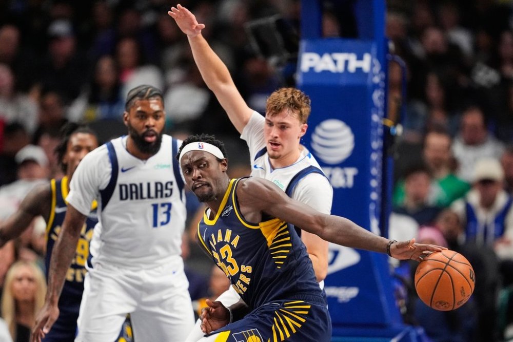 Indiana Pacers forward Pascal Siakam (43) loses control of the ball as Dallas Mavericks' Cooper Flagg defends in the second half of an NBA basketball game Wednesday, Oct. 29, 2025, in Dallas. (AP Photo/Tony Gutierrez)