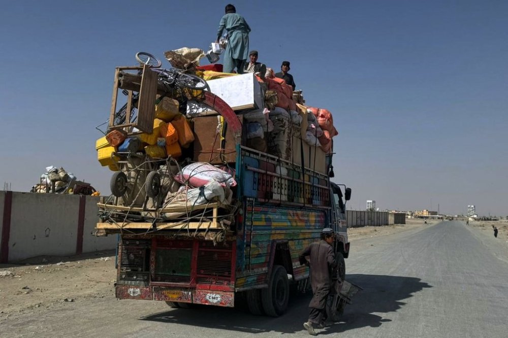 Afghan refugees prepare to leave for their homeland through a border crossing point which partially opens following Pakistan Afghanistan ceasefire truce, at a camp in Chaman, a border town on the Pakistan Afghan border, Sunday, Oct. 19, 2025. (AP Photo/H. Achakzai)
