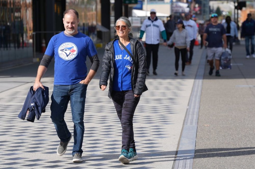 Toronto Blue Jays fans walk in Seattle prior to Game 3 of American League Championship Series baseball action between the Seattle Mariners and the Toronto Blue Jays, in Seattle, on Wednesday, Oct. 15, 2025. THE CANADIAN PRESS/Frank Gunn