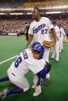 Montreal Expos pitcher Joey Eischen hugs Vladimir Guerrero Jr. as his father Vladimir looks on following their 7-2 victory over the Cincinnati Reds, in Montreal, on Sunday, Sept. 29, 2002. THE CANADIAN PRESS/Paul Chiasson