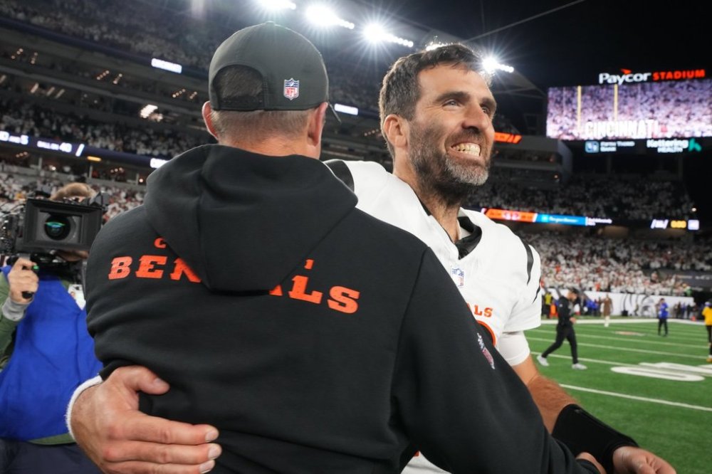 Cincinnati Bengals quarterback Joe Flacco, right, celebrates with head coach Zac Taylor, left, after an NFL football game against the Pittsburgh Steelers in Cincinnati, Thursday, Oct. 16, 2025. (AP Photo/Jeff Dean)