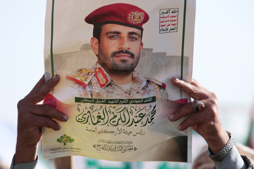 A Houthi supporter holds a poster of Maj. Gen. Muhammad Abdul Karim al-Ghamari, who died of wounds he suffered after an Israeli attack, during an anti-U.S. and anti-Israel rally in Sanaa, Yemen, Friday, Oct. 17, 2025. (AP Photo/Osamah Abdulrahman)