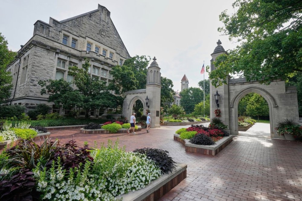 FILE - Guests walk on the campus of Indiana University, Thursday, July 17, 2025, in Bloomington, Ind. (AP Photo/Darron Cummings, File)
