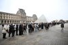 People queue outside the Louvre museum that remains closed for the day after Sunday's jewels robbery, Monday, Oct. 20, 2025 in Paris. (AP Photo/Emma Da Silva)