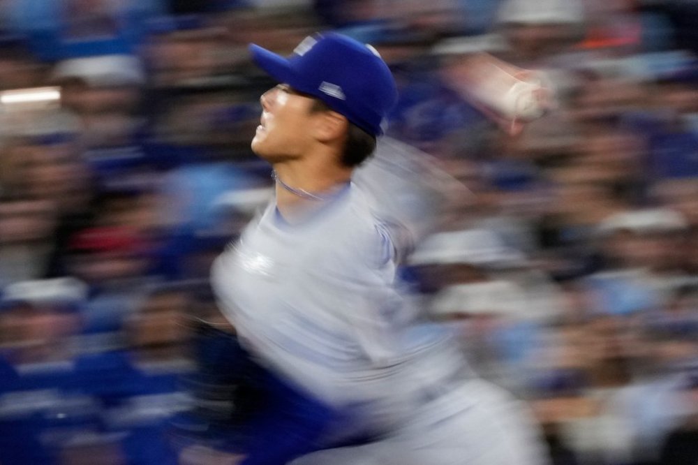 Los Angeles Dodgers pitcher Yoshinobu Yamamoto throws against the Toronto Blue Jays during the second inning in Game 2 of baseball's World Series, Saturday, Oct. 25, 2025, in Toronto. (AP Photo/Brynn Anderson)