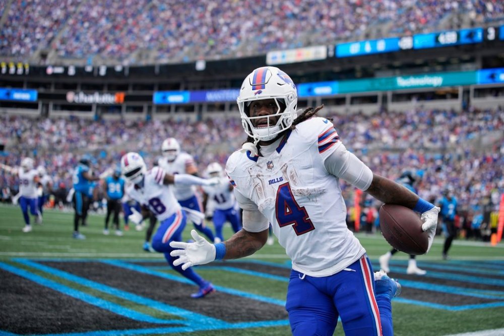 Buffalo Bills running back James Cook III (4) celebrates after scoring a touchdown against the Carolina Panthers during the second half an NFL football game, Sunday, Oct. 26, 2025, in Charlotte, N.C. (AP Photo/Jacob Kupferman)