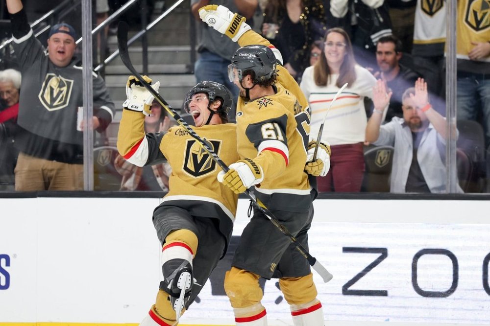 Vegas Golden Knights right wings Mitch Marner (93) and Mark Stone (61) celebrate after Marner's goal against the Calgary Flames during the second period of an NHL hockey game Saturday, Oct. 18, 2025, in Las Vegas. (AP Photo/Ian Maule)