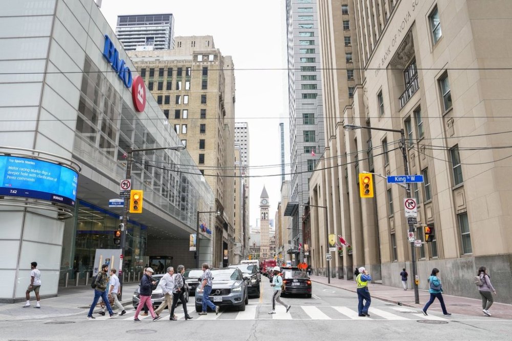 A general view of pedestrians crossing Bay St. in the financial district in Toronto, Friday, Sept. 8, 2023. THE CANADIAN PRESS/Andrew Lahodynskyj