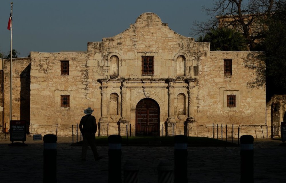 FILE - A ranger patrols the ground of the Alamo in San Antonio, Thursday, March 26, 2020. (AP Photo/Eric Gay, File)