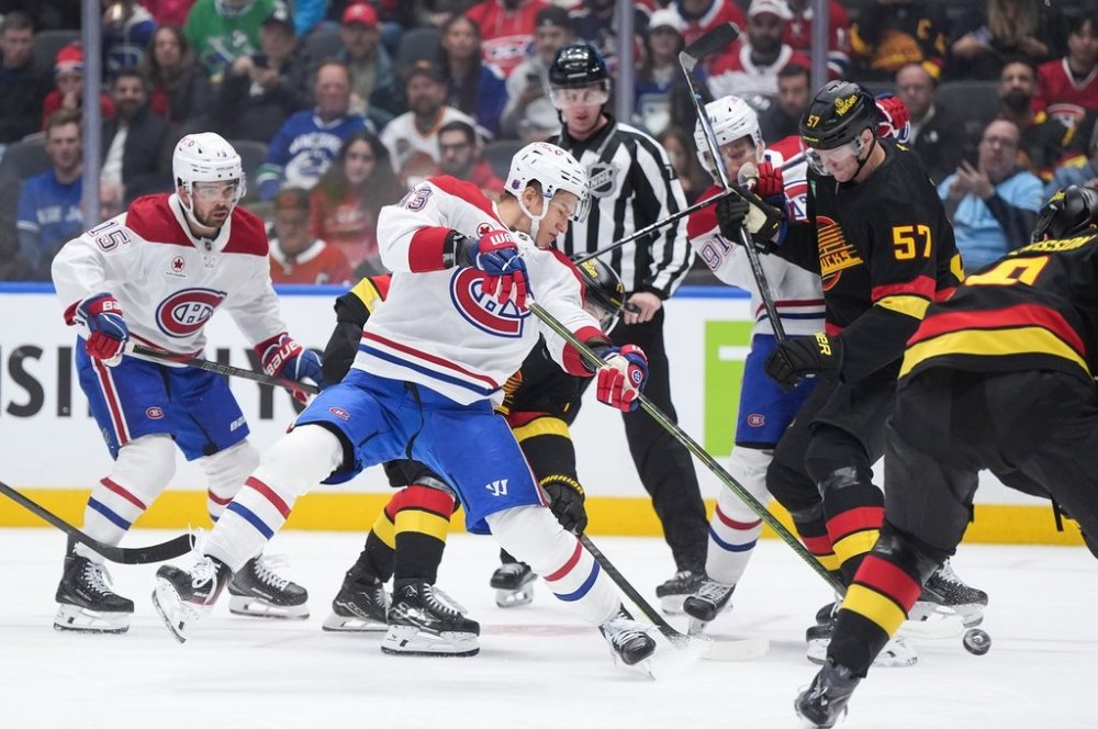 Montreal Canadiens' Ivan Demidov, centre, takes a shot on goal as Oliver Kapanen, back right, checks Vancouver Canucks' Tyler Myers, front right, during the first period of an NHL hockey game in Vancouver, on Saturday, Oct. 25, 2025. THE CANADIAN PRESS/Darryl Dyck
