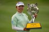 Miyu Yamashita of Japan holds the winning trophy after winning the LPGA Tour's Maybank Championship at Kuala Lumpur Golf and Country club in Kuala Lumpur, Malaysia, Sunday, Nov. 2, 2025. (AP Photo/Kien Huo)