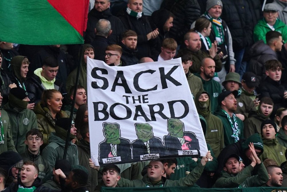 Celtic fans in the stands hold up a Sack The Board banner ahead of the William Hill Premiership soccer match against Dundee at Dens Park, Sunday Oct. 19, 2025. (Jane Barlow/PA via AP)