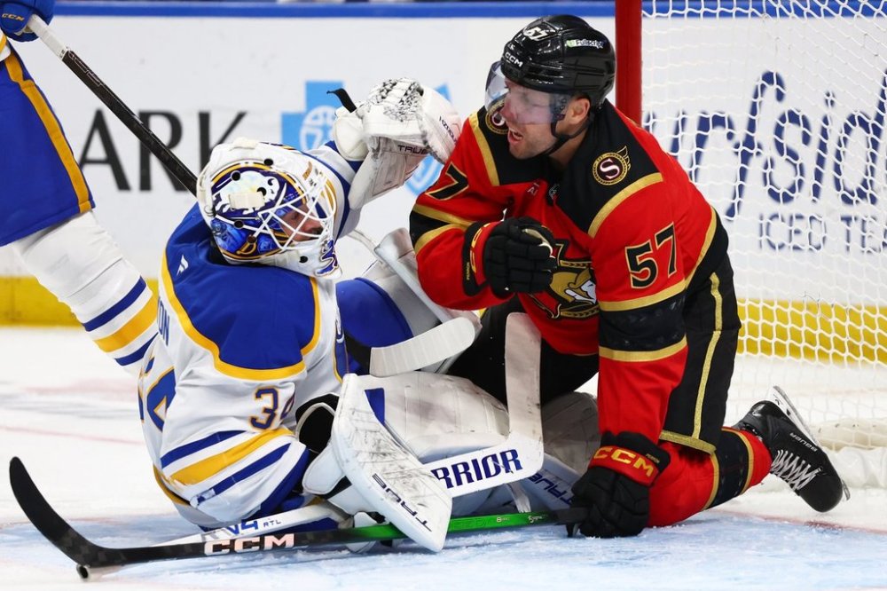 Ottawa Senators left wing David Perron (57) collides with Buffalo Sabres goaltender Alex Lyon (34) during the second period of an NHL hockey game Wednesday, Oct. 15, 2025, in Buffalo, N.Y. (AP Photo/Jeffrey T. Barnes)