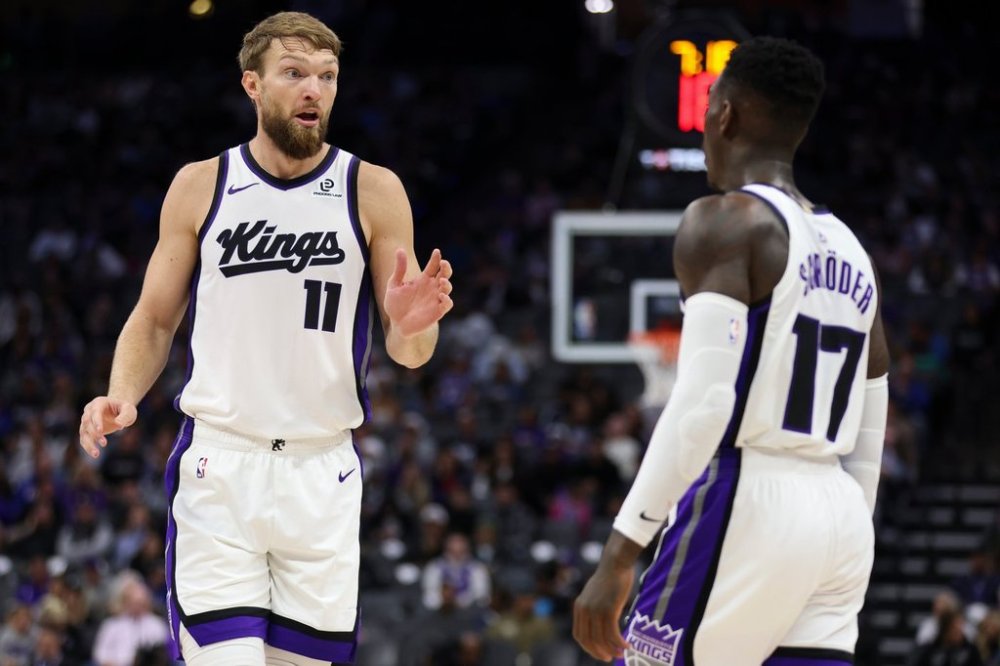 Sacramento Kings center Domantas Sabonis (11) and guard Dennis Schröder (17) talk during the first half of an NBA basketball preseason game against the Los Angeles Clippers, Wednesday, Oct. 15, 2025, in Sacramento, Calif. (AP Photo/Scott Marshall)