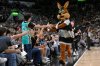 FILE - The Coyote, right, San Antonio Spurs' mascot, greets fans during the second half of an NBA basketball game against the Minnesota Timberwolves, Saturday, Nov. 2, 2024, in San Antonio. San Antonio won 113-103. (AP Photo/Darren Abate, File)