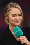 FILE - Soccer pundit Laura Woods smiles as she stands on the side line before the Women's Finalissima soccer match between England and Brazil at Wembley stadium in London, April 6, 2023. (AP Photo/Ian Walton, File)