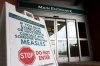 Warning signage for suspected cases of measles is seen outside the main entrance of Woodstock General Hospital in Woodstock, Ont., Thursday, May 22, 2025. THE CANADIAN PRESS/Nicole Osborne