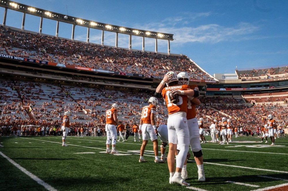 Texas quarterback Arch Manning (16) embraces Texas offensive lineman Connor Robertson (62) ahead of an NCAA college football game against Arkansas Saturday, Nov. 22, 2025, in Austin, Texas.(Sara Diggins/Austin American-Statesman via AP)