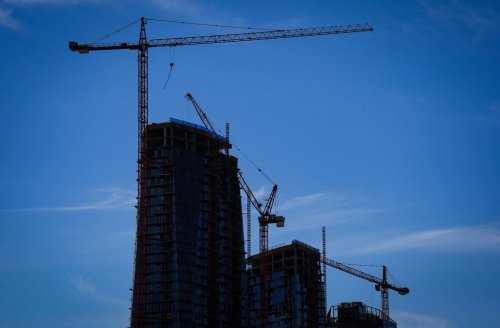 Senakw, an Indigenous-led housing development under construction, is silhouetted in Vancouver, B.C., Friday, Aug. 1, 2025. The project being built on the traditional lands of the Squamish Nation will have more than 6,000 rental units and 1,200 homes in a total of 11 towers when complete. THE CANADIAN PRESS/Darryl Dyck