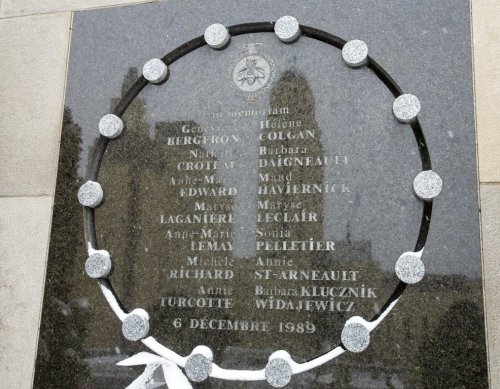 The tower of the University de Montreal is reflected in the school's memorial plaque that names the 14 victims on the 30th anniversary of the 1989 Ecole Polytechnique attack where a lone gunman killed 14 female students Friday, December 6, 2019 in Montreal.THE CANADIAN PRESS/Ryan Remiorz
