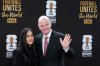 FIFA President Gianni Infantino and his wife Leena Al Ashqar pose for a photo as they arrive for a welcome reception ahead of the draw for 2026 soccer World Cup at the Kennedy Center in Washington, Thursday, Dec. 4, 2025. (AP Photo/Chris Carlson)