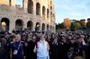 Italian pope singer Achille Lauro carries the 2026 Milan Cortina Winter Olympics torch in front of the Colosseum in Rome along its journey through Italy, Saturday, Dec. 6, 2025, a journey that will conclude in Milan in February 2026. (AP Photo/Gregorio Borgia)
