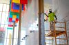 Odden Shaw painting over a gold coloured column inside the Hall of Nations at the Kennedy Center for Performing Arts in Washington, Friday, Oct. 24, 2025, in preparation for upcoming FIFA World Cup 2026 Final Draw. (AP Photo/Pablo Martinez Monsivais)