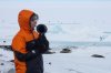 In this photo provided by Antarctica New Zealand, Natalie Paine plays a plastic French horn at Scott Base in Antarctica, on Nov. 16, 2025. (Anthony Powell/Antarctica New Zealand via AP)