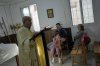Priest Maurice El Khoury, left, leads Sunday Mass inside a room usually used as a residence for visiting bishops next to St. George Melkite Catholic Church, which was destroyed in an Israeli airstrike, in the town of Dardghaya, southern Lebanon, Sunday, Nov. 16, 2025. (AP Photo/Hassan Ammar)