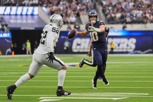Los Angeles Chargers quarterback Justin Herbert (10) looks to pass as Las Vegas Raiders linebacker Elandon Roberts (52) defends during the second half of an NFL football game, Sunday, Nov. 30, 2025, in Inglewood, Calif. (AP Photo/Jae C. Hong)
