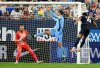 United States' Alex Freeman (16) scores on Uruguay goalie Cristopher Fiermarin (1) as Rodrigo Bentancur (6) defends during the first half of an international friendly soccer game Tuesday, Nov. 18, 2025, in Tampa, Fla. (AP Photo/Jason Behnken)