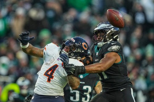 Chicago Bears running back D'Andre Swift (4), left, and Philadelphia Eagles linebacker Nakobe Dean (17) vie for a loose ball during the first half of an NFL football game, Friday, Nov. 28, 2025, in Philadelphia. (AP Photo/Matt Rourke)