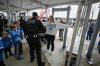 Fans enter through a security checkpoint before an NFL football game between the Washington Commanders and the Detroit Lions Sunday, Nov. 9, 2025, in Landover, Md. (AP Photo/Nick Wass)