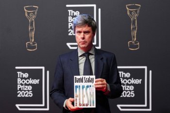 Author David Szalay poses with his book 'Flesh' as he arrives for the Booker Prize 2025 ceremony at Old Billingsgate in London, Monday, Nov. 10, 2025. (AP Photo/Kirsty Wigglesworth)