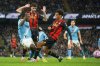 Manchester City's Jeremy Doku, left, in action against Bournemouth's Tyler Adams, right, during the English Premier League soccer match between Manchester City and Bournemouth in Manchester, England, Sunday, Nov. 2, 2025. (AP Photo/Ian Hodgson)
