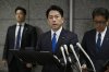Japan's Defense Minister Shinjiro Koizumi, center, speaks to the media, as Japan announced that a Chinese military aircraft locked its radar on Japanese jets, at the ministry in Tokyo, Sunday, Dec. 7, 2025. (Kyodo News via AP)