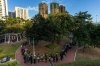 People holds flower and line up near the site to mourn the victims of the deadly Wednesday fire at Wang Fuk Court, a residential estate in the Tai Po district of Hong Kong's New Territories on Saturday, Nov. 29, 2025. THE CANADIAN PRESS/AP-Chan Long Hei