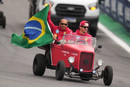 Ferrari driver Lewis Hamilton of Britain, left, and Ferrari driver Charles Leclerc of Monaco wave to the crowd during the opening parade at the Brazilian Formula One Grand Prix at the Interlagos race track in Sao Paulo, Sunday, Nov. 9, 2025. (AP Photo/Andre Penner)