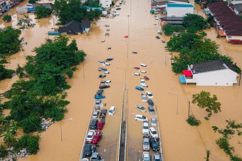 Cars and houses are submerged in floodwaters in Songkhla province, southern Thailand, Wednesday, Nov. 26, 2025. (AP Photo/Arnun Chonmahatrakool)