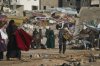 A man Palestinian man carries bags of firewood after collecting them from the rubbish in Khan Younis, southern Gaza Strip, on Saturday, Nov. 15, 2025.(AP Photo/Abdel Kareem Hana)
