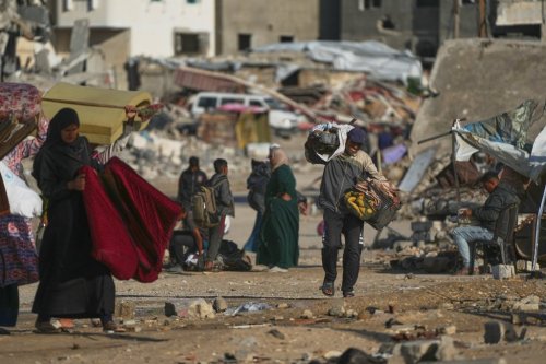 A man Palestinian man carries bags of firewood after collecting them from the rubbish in Khan Younis, southern Gaza Strip, on Saturday, Nov. 15, 2025.(AP Photo/Abdel Kareem Hana)
