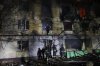 Rescue workers try to put out a fire of residential building burning after a Russian attack on Zaporizhzhia, Ukraine, Wednesday, Nov. 26, 2025. (AP Photo/Kateryna Klochko)