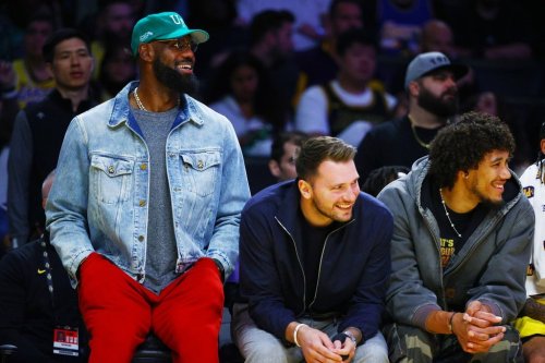 Los Angeles Lakers forward LeBron James (23) and Los Angeles Lakers guard Luka Doncic (77) watch from the bench during the second half of an NBA basketball game against the Portland Trail Blazers, Monday, Oct. 27, 2025, in Los Angeles. (AP Photo/Ethan Swope)